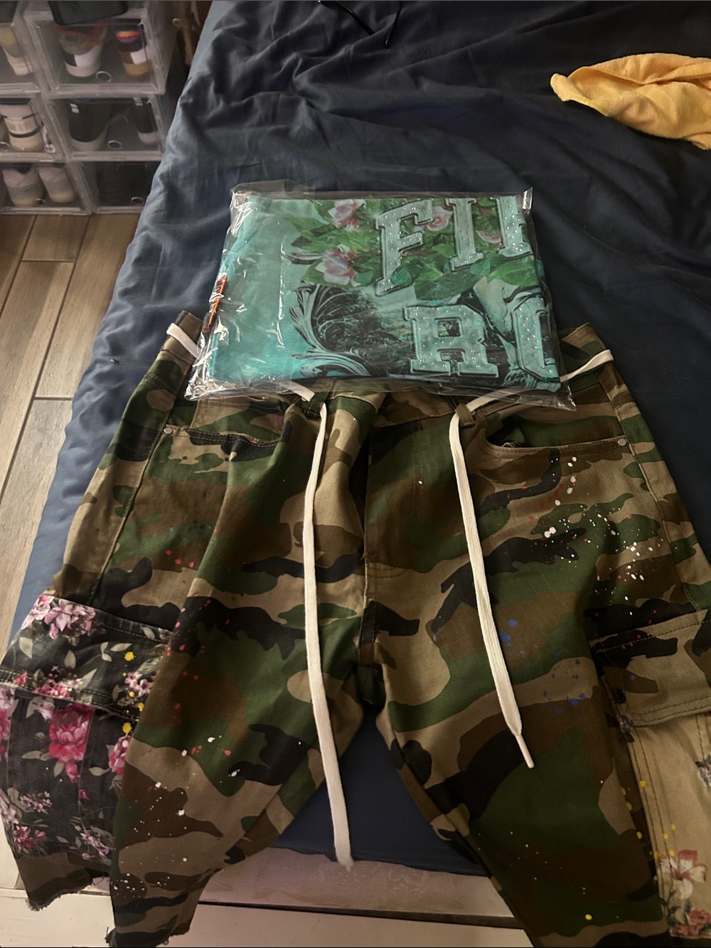 Camo Paint-Splatter Cargo Joggers with Floral Patch. Both are First Row.